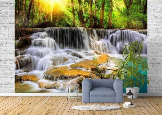 Wall Mural - Cascade surrounded by rocks against the backdrop of a forest