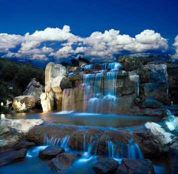 Wall Mural - Waterfall against the blue sky