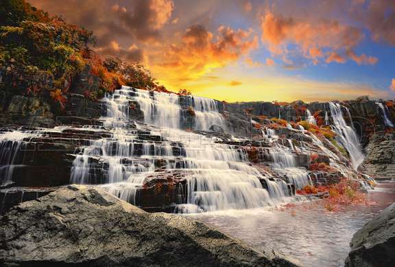 Wall Mural - Rocky waterfall at sunset