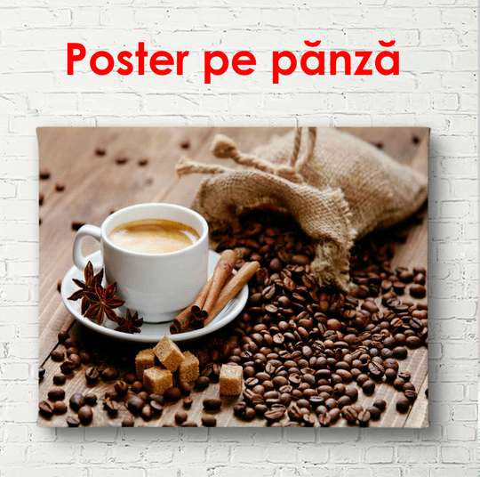 Постер - Мешок с кофейными зернами на столе рядом с кофе в белой чашке, 90 x 60 см, Постер в раме, Еда и Напитки