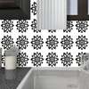 Ceramic tiles with black floral ornaments
