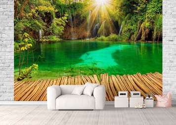 Wall Mural - Bridge against the backdrop of a cascade surrounded by green plants