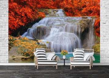 Wall Mural - Coast with yellow plants in the mountains against the backdrop of a waterfall