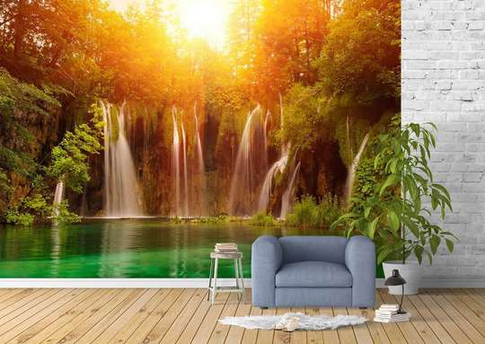 Wall Mural - Cascade on the background of a forest lit by the sun