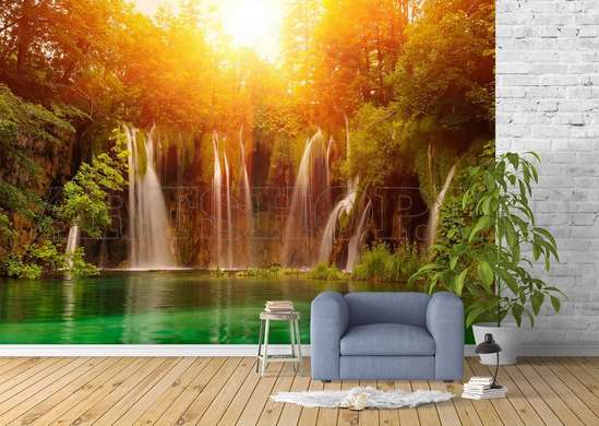 Wall Mural - Cascade on the background of a forest lit by the sun