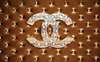 Wall Mural - Chanel sign on brown background