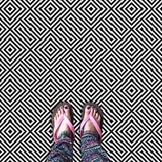 Tile in op art style with black and white diagonal lines
