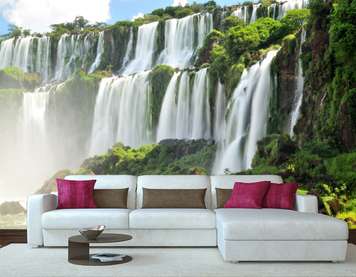 Wall Mural - Beautiful waterfall on the background of green hills