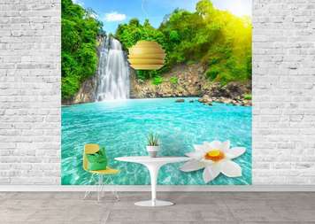 Wall Mural - Waterfall in which a white flower floats against the backdrop of a forest