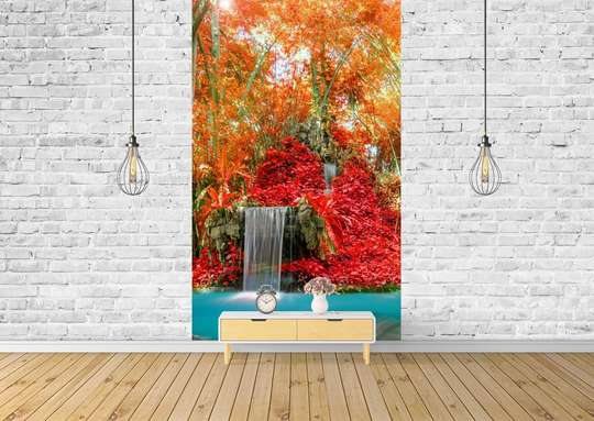 Wall Mural - A small waterfall against the background of red plants and trees